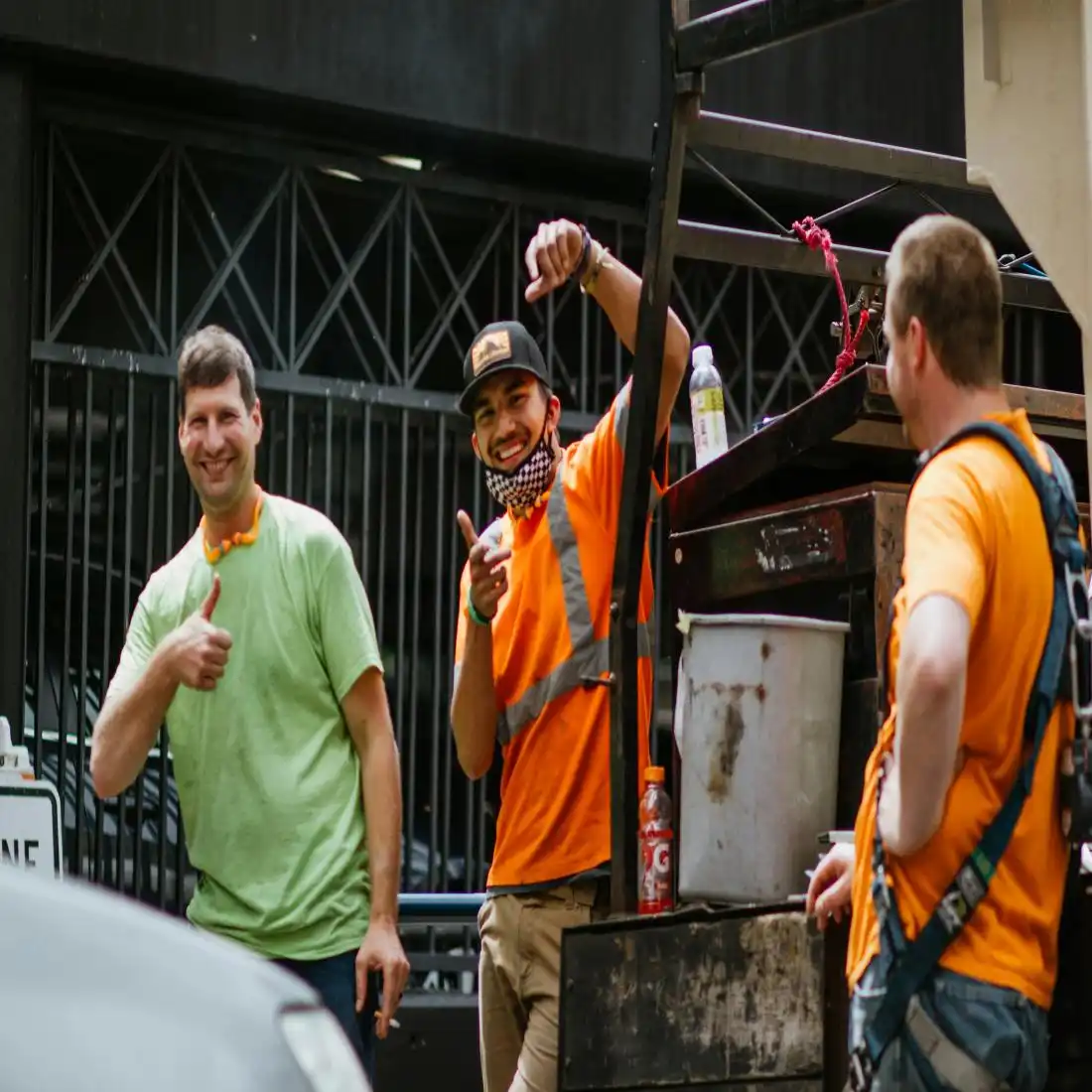 Three men are smiling while working